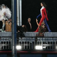 Model presents creations while walking a catwalk erected along the Passerelle Debilly bridge on the Seine river during the opening ceremony of the...