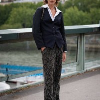 Model wears a blue blazer, printed pants, black loafers and black Chanel bag, outside Chanel, during the Haute Couture Fall/Winter 2023/2024 as part...
