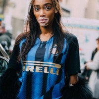 Model Winnie Harlow wears her hair in a high ponytail and wears a blue Pirelli soccer/football jersey after the Byblos show on Day 1 Milan Fashion...