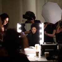 Models have their hair and make up prepared backstage, ahead of presenting creation for the Paul Costelloe Spring/Summer 2025 collection, at London...