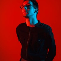 models hipster man with glasses on a red glowing background - fashion stock pictures, royalty-free photos & images