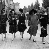 Models outside the fashion exhibition at Holland Park in London wearing comtemporary dropped waist dresses and styles of 25 years ago.