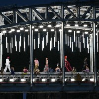 Models present creations while walking a catwalk erected along the Passerelle Debilly bridge along the Seine river during the opening ceremony of the...