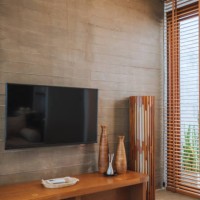 modern living room with wooden panel decor and a sleek television setup stylish interior design with a wooden media console and natural lighting - home decoration stock pictures, royalty-free photos & images