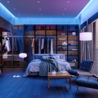 modern slaapkamerinterieur 's nachts met neonlicht. rommelig bed, kleding in kast, fauteuils en vloerlamp. - home decoration stockfoto's en -beelden
