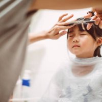 mom cutting lovely little daughter's hair - hairstyle stock pictures, royalty-free photos & images