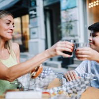 mom taking her kid to the burger place - junk food stock pictures, royalty-free photos & images