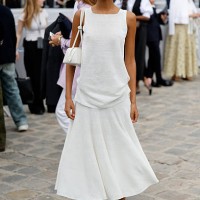Mona Tougaard wears white top, white midi skirt, white bag, white ballet flats, outside Dior, during the Menswear Spring/Summer 2026 show as part of...