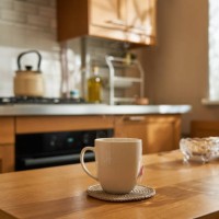 morning in home kitchen, hot tea in cup on wooden table, sunlight from window. - food stock pictures, royalty-free photos & images