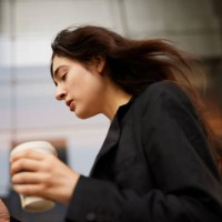 morning rush: woman speeds to work with takeaway coffee and smartphone. - junk food stock pictures, royalty-free photos & images