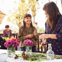 mother and daughter arranging flowers on table in backyard - garden decoration stock pictures, royalty-free photos & images
