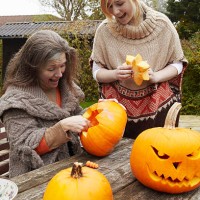 mother and daughter carving pumpkins - garden decoration stock pictures, royalty-free photos & images