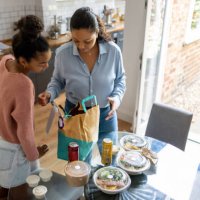 mother and daughter eating take out food at home - junk food stock pictures, royalty-free photos & images