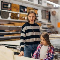 mother and daughter enjoy shopping and furnishing a new apartment together, choosing carpets - home decoration stock pictures, royalty-free photos & images