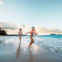 mother and daughter play on the beach - travel stock pictures, royalty-free photos & images