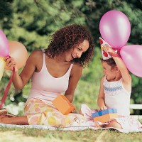 mother and daughter sitting in the garden face to face at a birthday party - garden decoration stock pictures, royalty-free photos & images