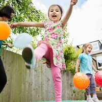 mother and daughters playing in garden with balloons - garden decoration stock pictures, royalty-free photos & images