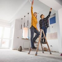 mother and son painting wall at home - home decoration stock pictures, royalty-free photos & images