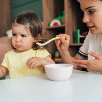 mother feeding her girl - food stock pictures, royalty-free photos & images