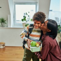 mother kissing her son who is going to school - food stock pictures, royalty-free photos & images