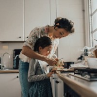 mother showing daughter how to peel an apple - food stock pictures, royalty-free photos & images