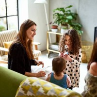 mother sitting on sofa at home with children - home decoration stock pictures, royalty-free photos & images