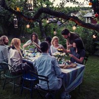 multi-ethnic friends having food at dining table in yard - garden decoration stock pictures, royalty-free photos & images