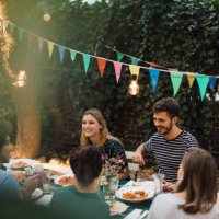 multi-ethnic young friends enjoying dinner at table during garden party - garden decoration stock pictures, royalty-free photos & images