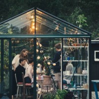 multi-ethnic young friends enjoying garden dinner party in conservatory at back yard - garden decoration stock pictures, royalty-free photos & images