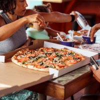 multi-generation family eats takeout pizza together - junk food stock pictures, royalty-free photos & images