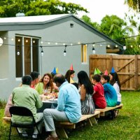 multi-generation family enjoying birthday party - garden decoration stock pictures, royalty-free photos & images