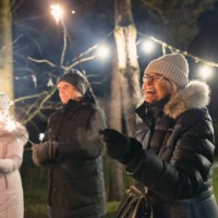 multi-generation family enjoying sparklers in the backyard on christmas eve - garden decoration stock pictures, royalty-free photos & images