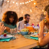 multi-generation family having dinner outdoors on an american national holiday - junk food stock pictures, royalty-free photos & images