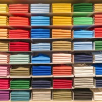 multi coloured polo shirts on eight shelves stacked in a store, spain - fashion stock pictures, royalty-free photos & images