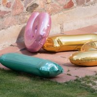 multicolored number balloons lie in backyard - garden decoration stock pictures, royalty-free photos & images