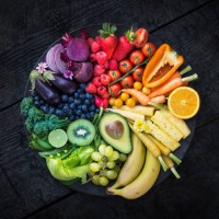 multicoloured fruit and vegetables in a black bowl on a burnt surface. - food stock pictures, royalty-free photos & images