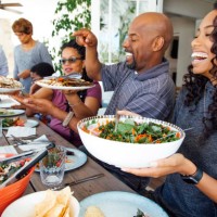multigenerational family enjoy meal together on patio - food stock pictures, royalty-free photos & images