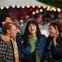 multiracial friends laughing amidst bubbles - concert stock pictures, royalty-free photos & images