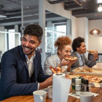 multiracial group of business people, eating a pizza for their lunch break at cafeteria - junk food stock pictures, royalty-free photos & images