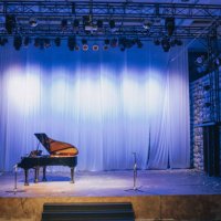 music stage theater with grand piano and white backdrop illuminated with stage light - concert stock pictures, royalty-free photos & images
