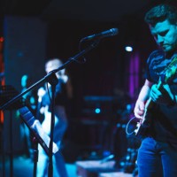 musicians playing electric guitar and singing on stage - concert stock pictures, royalty-free photos & images