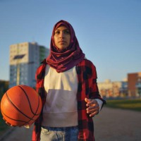 muslim young woman outdoors in the city, with basketball. - fashion stock pictures, royalty-free photos & images