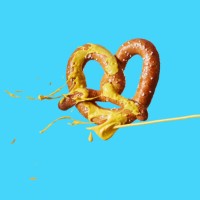 mustard squirting on pretzel - junk food stock pictures, royalty-free photos & images