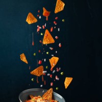 nachos levitating against black background,vadodara,gujarat,india - food stock pictures, royalty-free photos & images