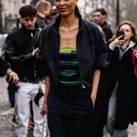 Nara Smith is seen wearing a black jacket, striped Miu Miu shirt, black pants and brown and white bag outside the Miu Miu show during the Womenswear...