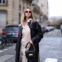 Natalia Verza wears parachute cargo pants in gray by Munthe, a layering sweater by Gerard Darel, a shirt by Munthe, a black oversized leather biker...