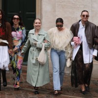 Nicole Huisman seen wearing brown Ganni sunnies, gold hoop earrings, colorful pearl necklace, small rose colored Prada Cleo handbag, colorful printed...