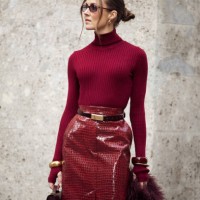 Nina Sandbech wears burgundy pencil skirt with reptile print, burgundy turtleneck, belt, burgundy bag, golden statement bracelets during the Milan...