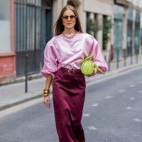 Nina Sandbech wears burgundy skirt and pink top homemade, green bag Mietis, sunglasses Loewe during Womenswear Spring/Summer 2025 as part of Paris...