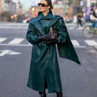 Nina Sandbech wears Celine sunglasses, black gloves, green leather coat, black boots, bag with leopard print, earrings on her way to Forza Collective...